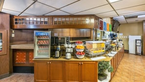 A buffet setup with a refrigerator, microwave, and various food items. - Comfort Inn & Suites Edmonton Downtown (Edmonton)