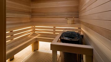 A sauna with wooden benches and a bench heater.