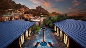 A courtyard with a central water feature, surrounded by buildings with metal roofs and stone pathways. - Sanctuary Camelback Mountain Resort and Spa (Paradise Valley)
