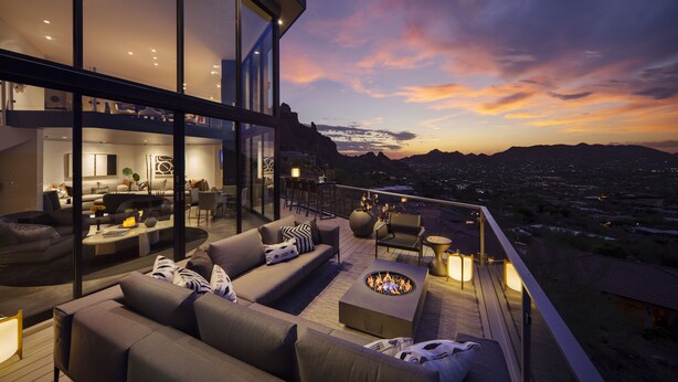 A modern outdoor living area with a fire pit, comfortable seating, and a city view at dusk. - Sanctuary Camelback Mountain Resort and Spa (Paradise Valley)
