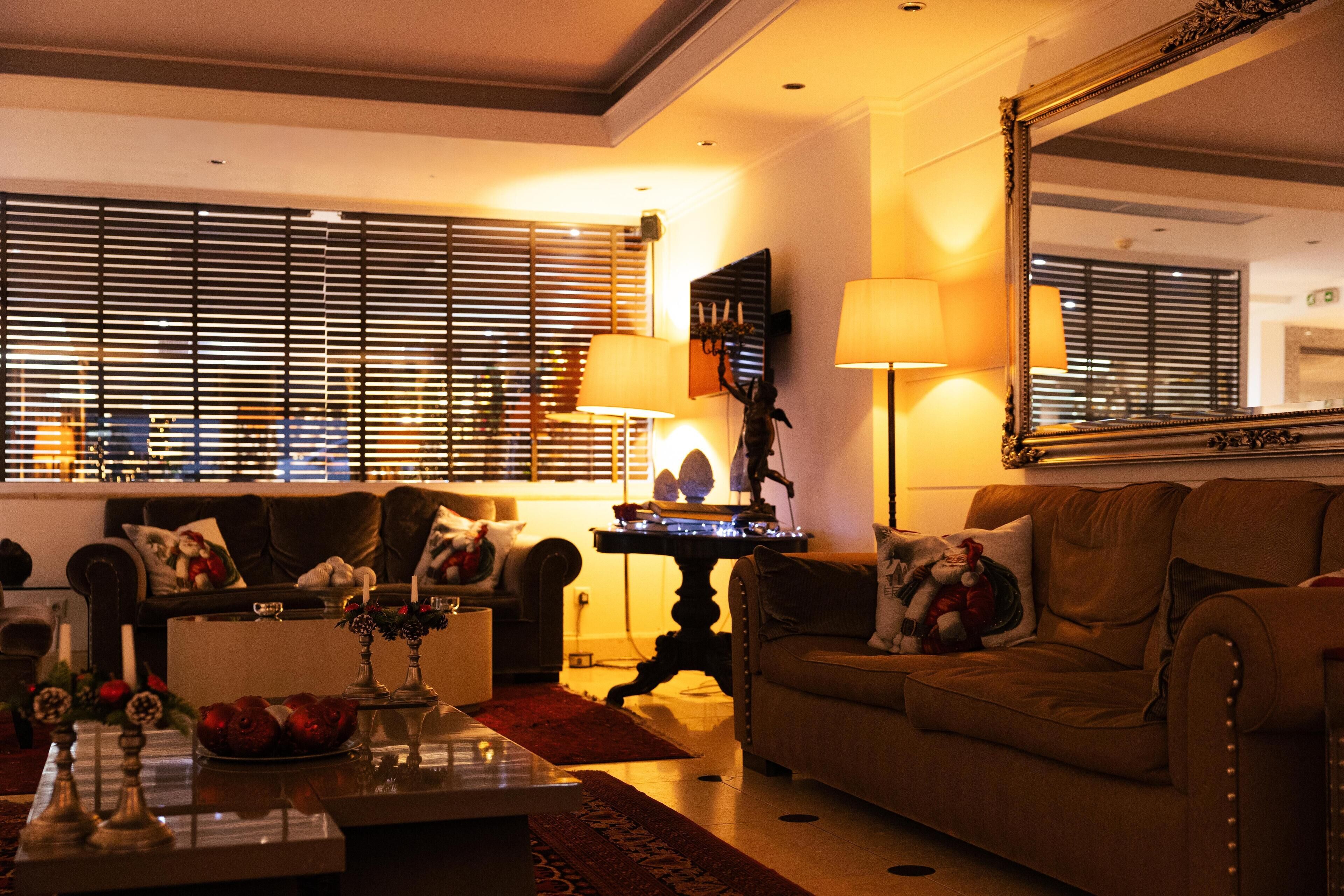 A cozy living room with a sofa, a coffee table, and a lamp.