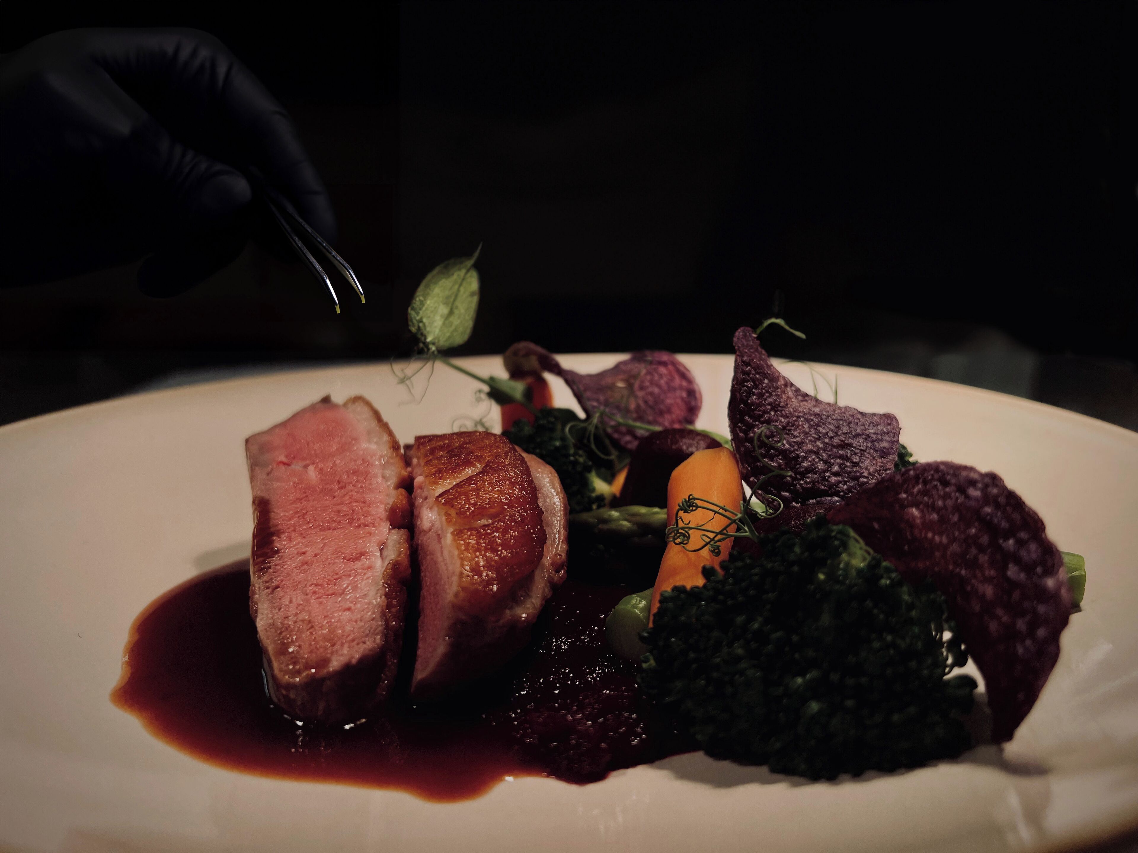 Un plat composé de tranches de viande, de légumes et d’une sauce foncée.