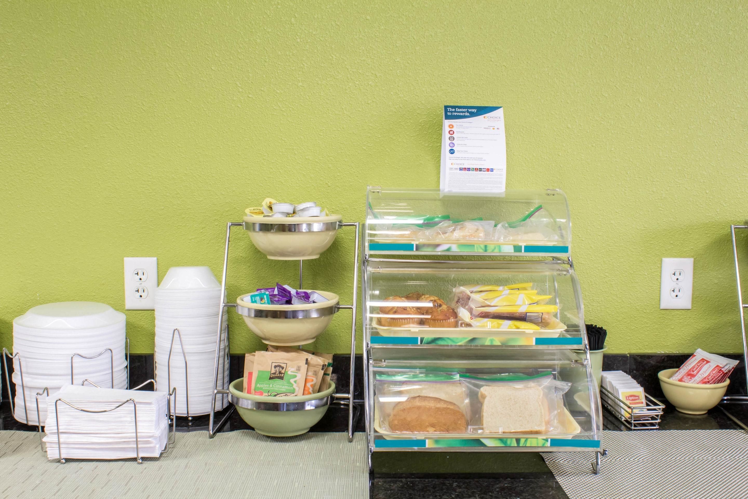 A buffet setup with various food items and containers.