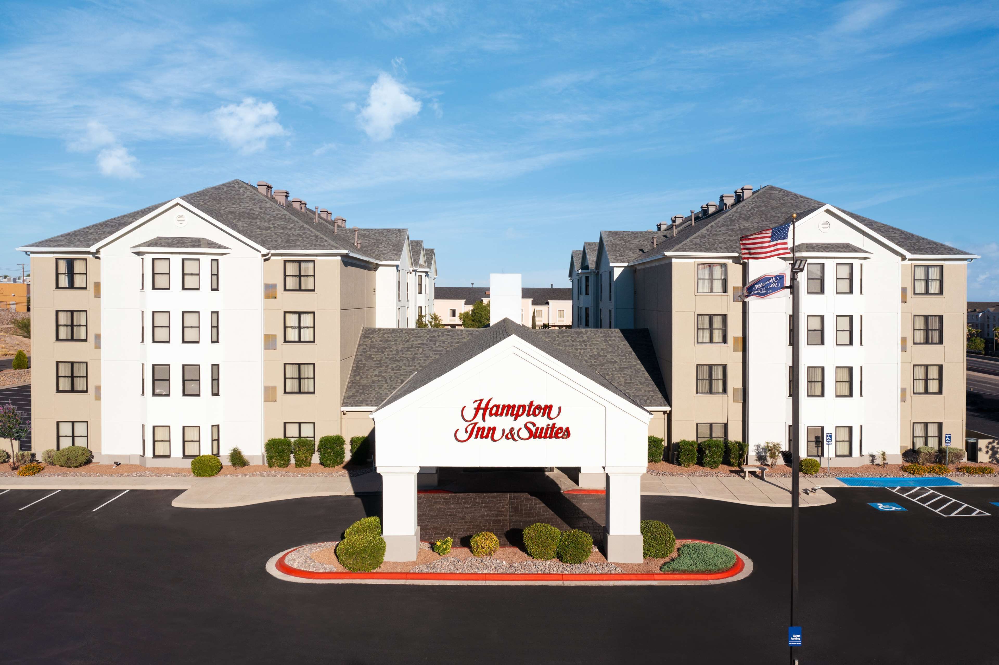 Ein Hampton Inn & Suites Hotel mit zentralem Eingang und zwei Flügeln.