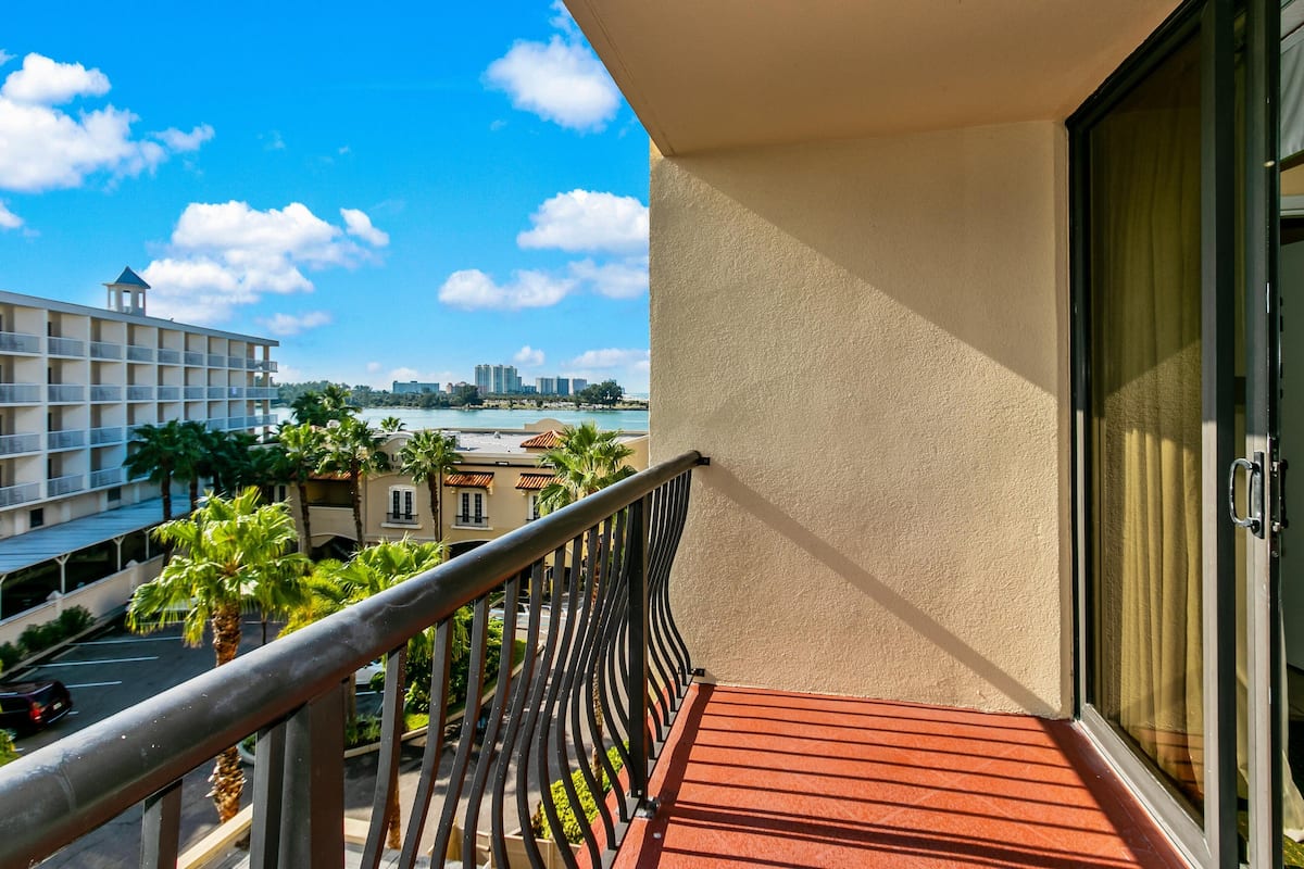 Enjoy a city view from the balcony with a clear view of the surrounding area, including palm trees and a body of water.