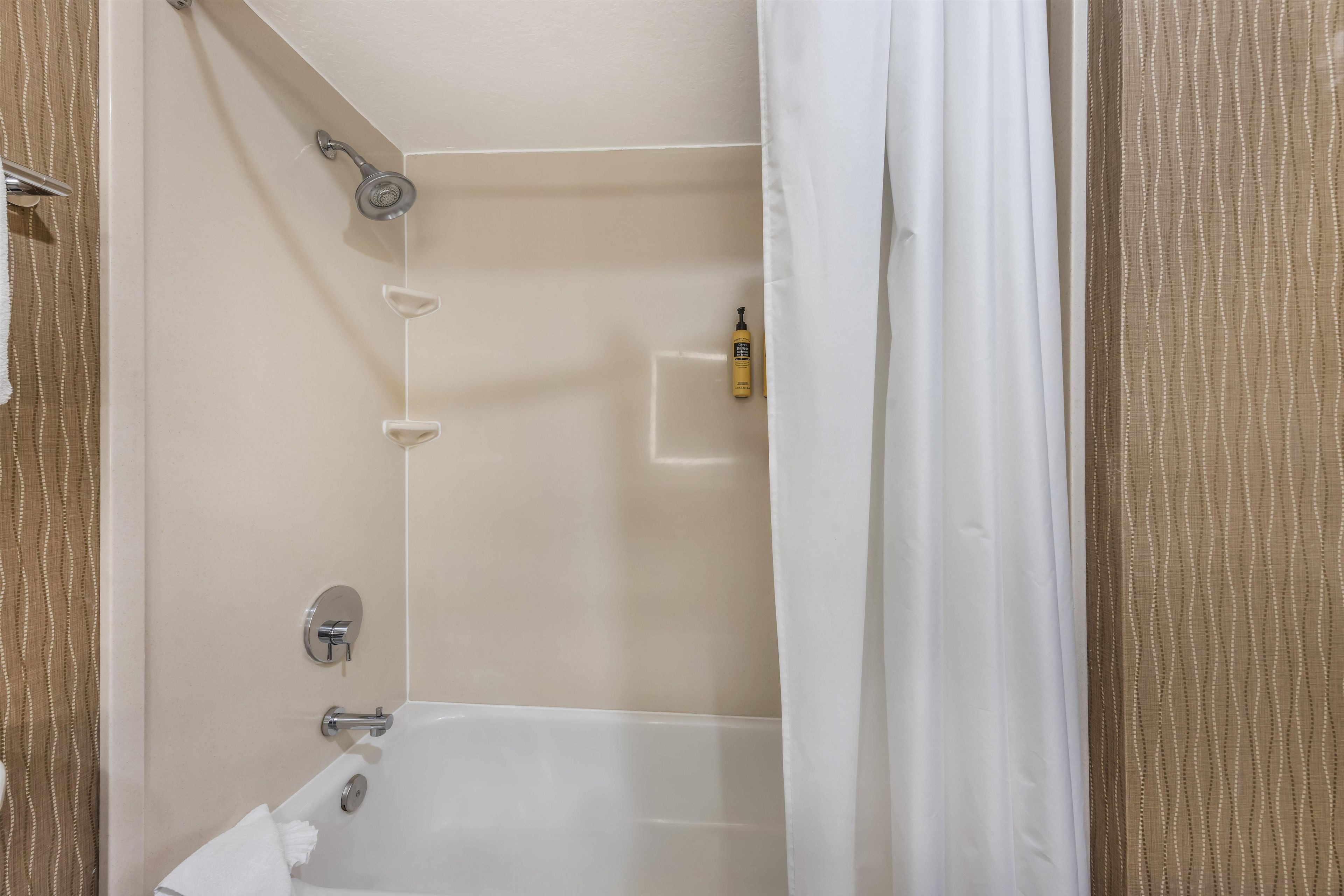 A bathroom with a bathtub, a shower, and a toilet.