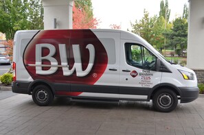 A white van with red and black branding, parked on a paved area.