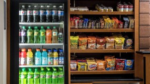 A corner market with a refrigerated beverage cooler stocked with various sodas and a freezer section. - Fairfield Inn & Suites by Marriott Knoxville/East (Knoxville)