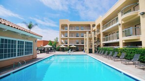 A swimming pool surrounded by lounge chairs and umbrellas, with a building labeled 'POOL SIDE' in the background. - Fairfield Inn by Marriott Anaheim Hills Orange County (Anaheim)