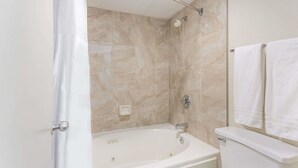 A bathroom with a bathtub, shower, and toilet. - Days Inn by Wyndham Winston Salem North (Winston-Salem)