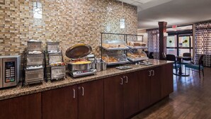 A buffet area with various food stations, including a hot grill, a buffet line, and a display case with pastries. - Best Western Plus Galleria Inn & Suites (Memphis)