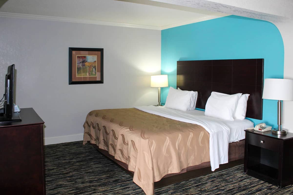 Premium bedding, desk, laptop workspace, blackout drapes