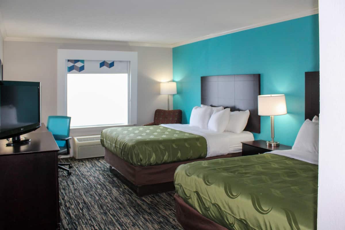 Premium bedding, desk, laptop workspace, blackout drapes
