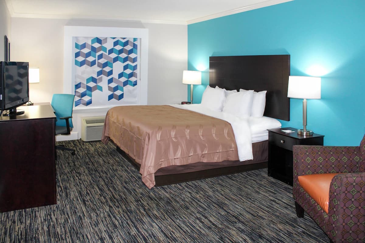 Premium bedding, desk, laptop workspace, blackout drapes