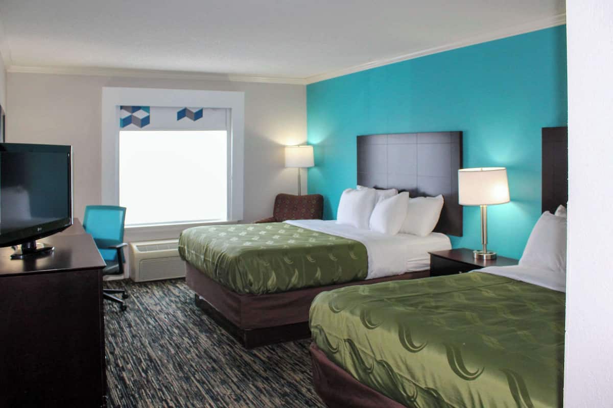 Premium bedding, desk, laptop workspace, blackout drapes