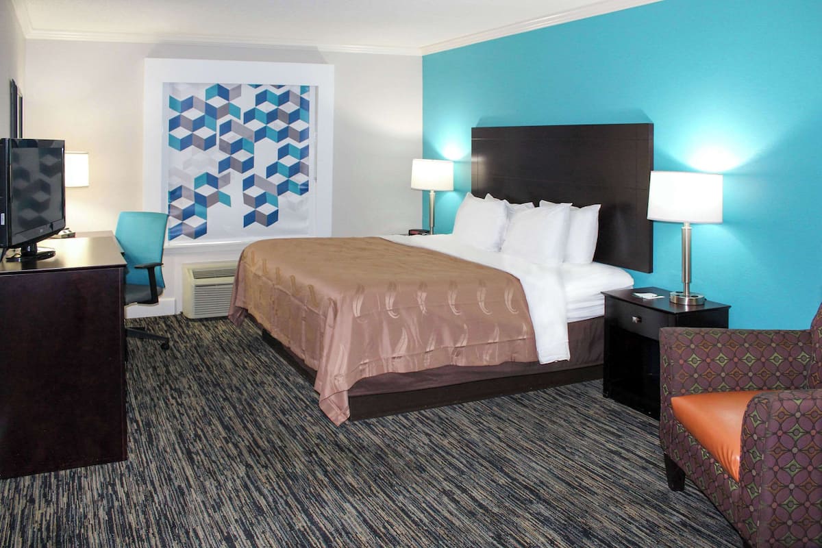 Premium bedding, desk, laptop workspace, blackout drapes