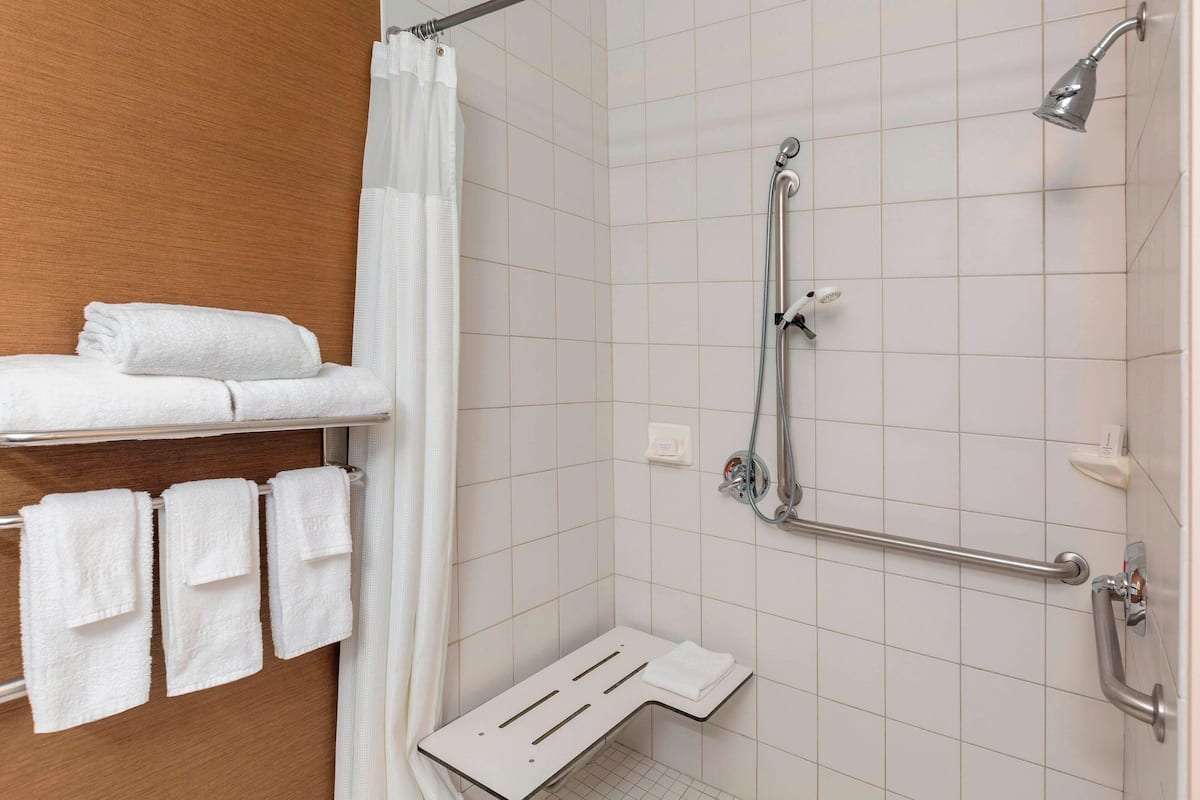 combined shower/bathtub, designer toiletries, hair dryer, towels