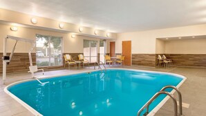 An indoor swimming pool with clear water, surrounded by yellow chairs and a sun lounger. - Fairfield Inn & Suites Abilene (Abilene)