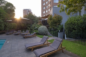 Seasonal outdoor pool, open 10:00 AM to 8:00 PM, pool umbrellas