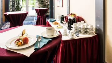 A dining table set with a dessert plate, a cup of coffee, and a variety of condiments and utensils.