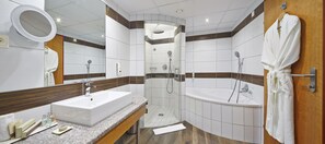 Features a large sink, walk-in shower, and standalone bathtub.