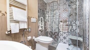 A bathroom with a shower, toilet, and bathtub.