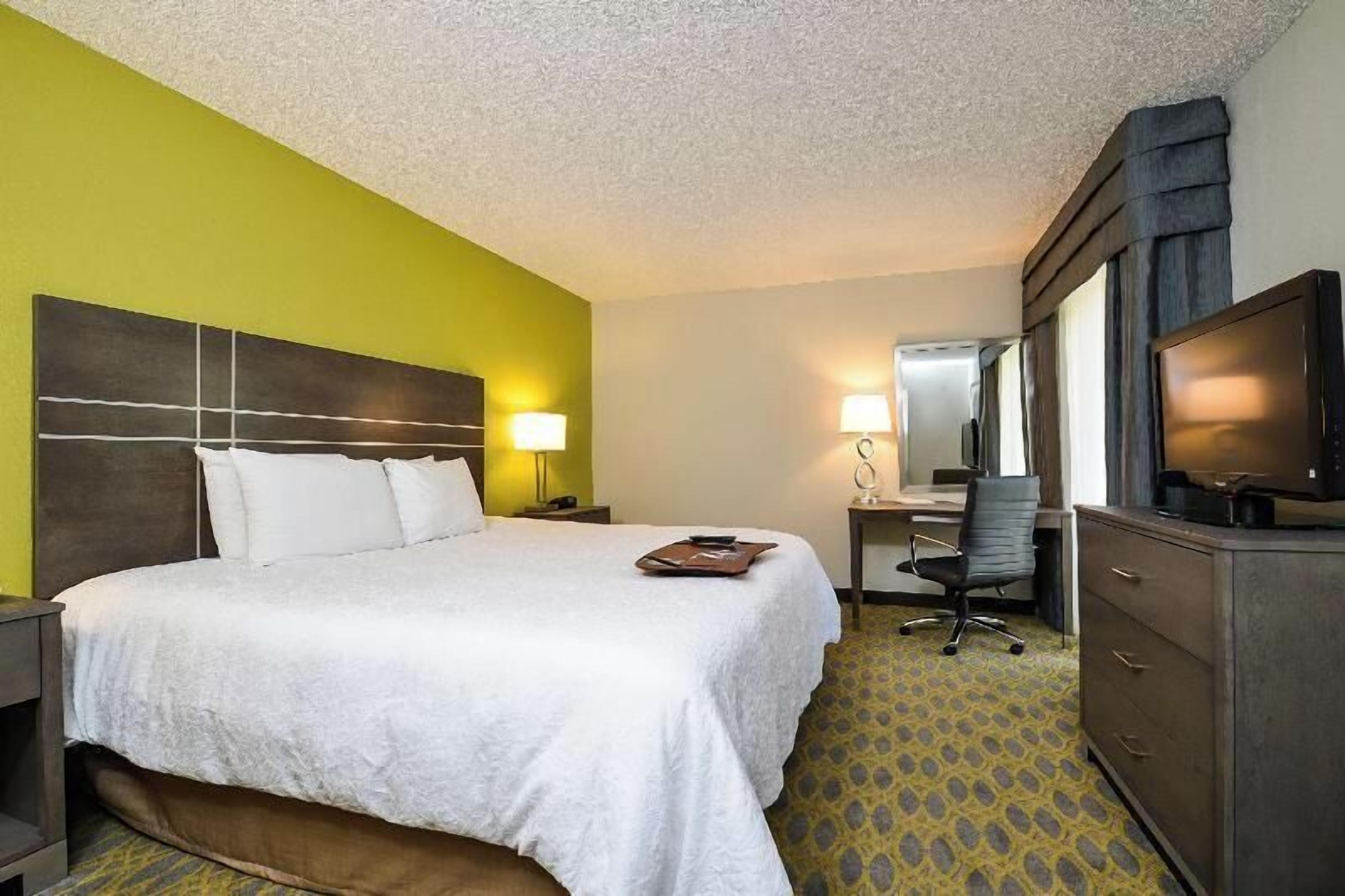 Premium bedding, desk, laptop workspace, blackout drapes