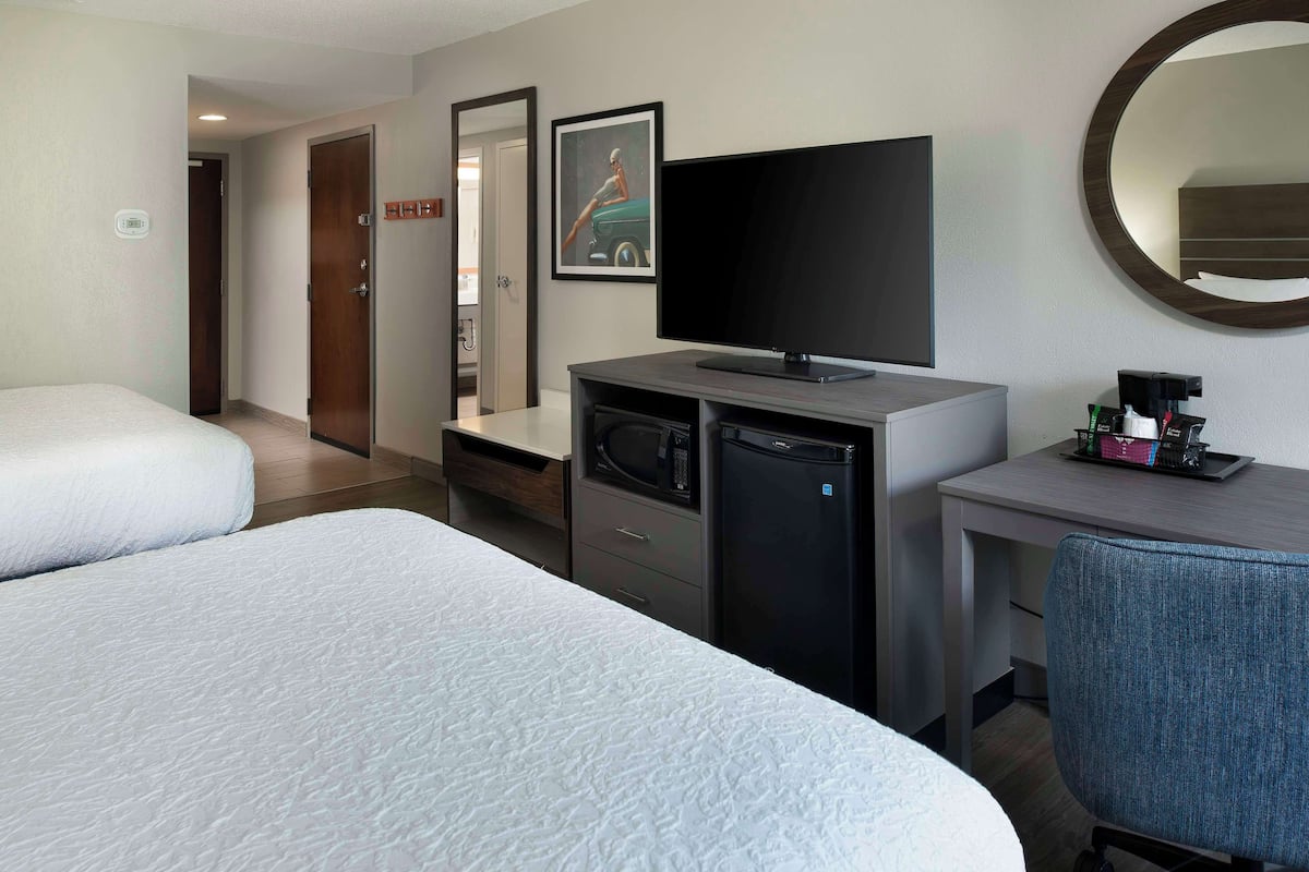 Premium bedding, desk, laptop workspace, blackout drapes