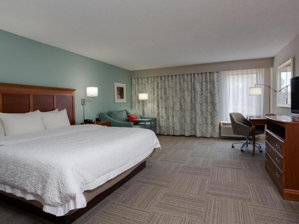 Premium bedding, desk, laptop workspace, blackout drapes
