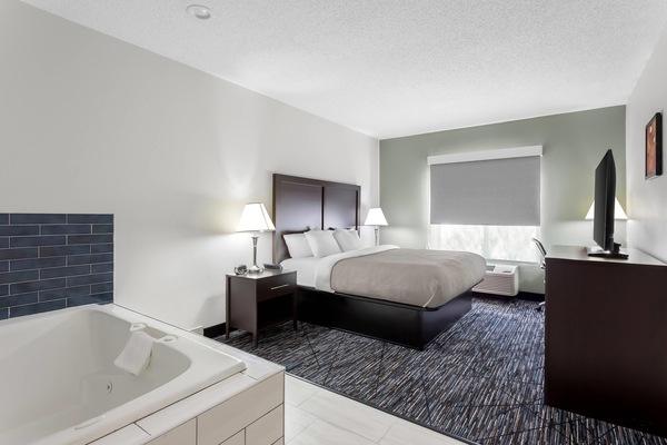 Suite, Non Smoking, Jetted Tub (1 King Bedroom) | Desk, iron/ironing board, free cribs/infant beds, rollaway beds