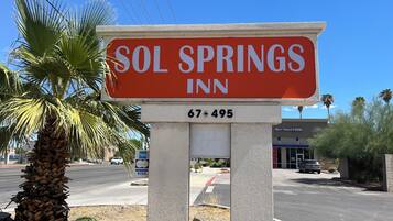 A sign for Sol Springs Inn with a contact number.