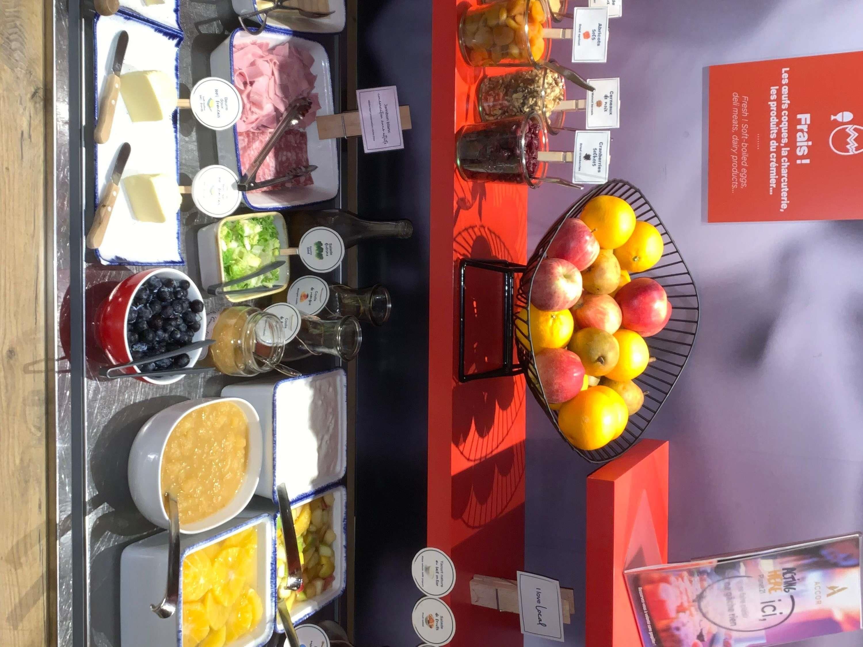 A buffet with various food items and condiments.