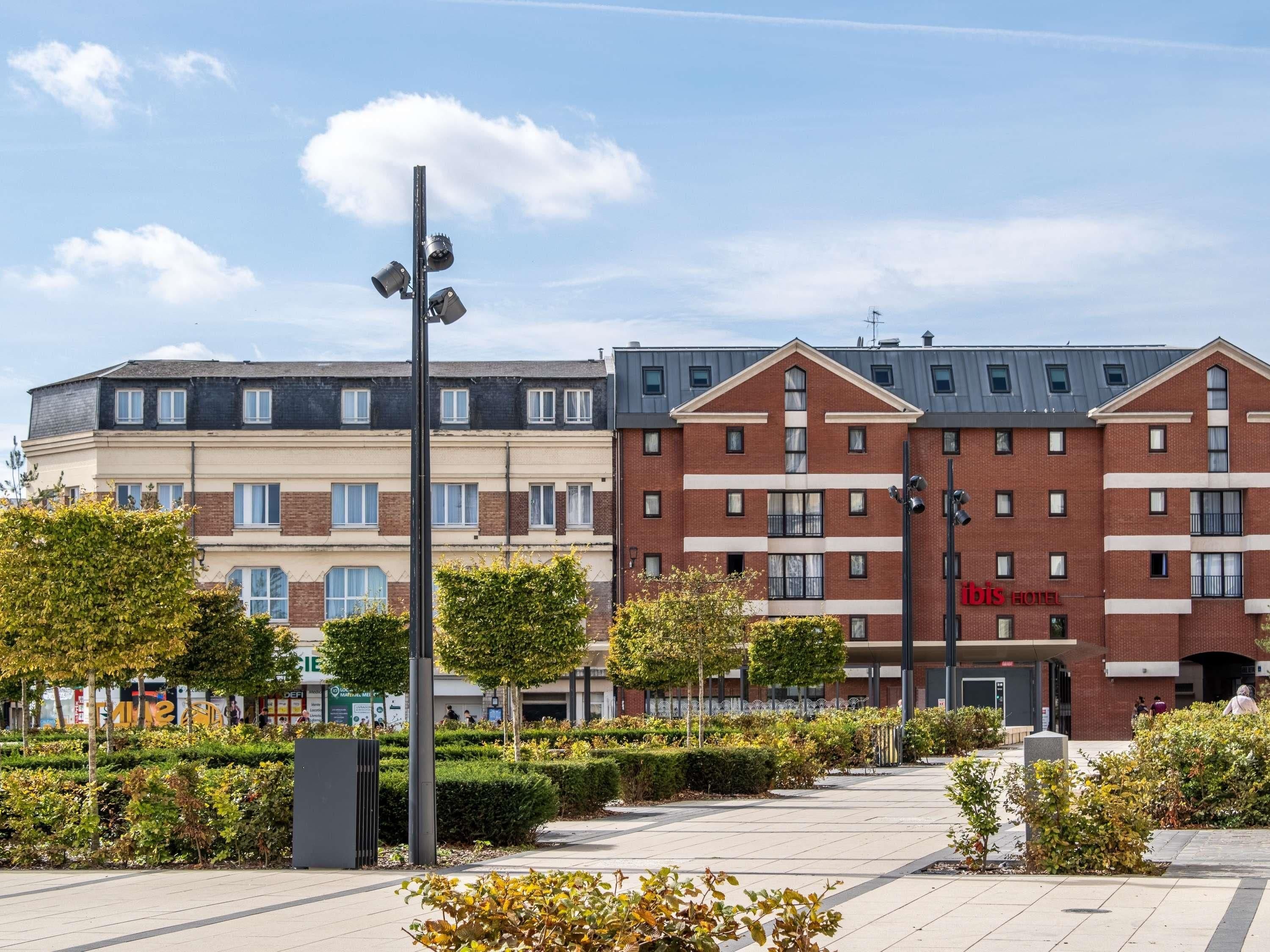 A hotel with a modern design, featuring a brick facade and a flat roof.