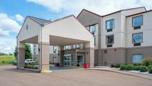 A modern hotel with a covered entrance, multiple windows, and a parking area. - Red Roof Inn PLUS+ & Suites Vicksburg (Vicksburg)