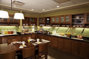 A breakfast buffet with a variety of food items, a coffee station, and a seating area with chairs and a table. - Hyatt Place Atlanta Downtown (Atlanta)