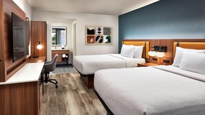 A hotel room with two beds, a desk, a chair, a TV, and a wall with artwork. - La Quinta Inn & Suites by Wyndham Thousand Oaks-Newbury Park (Thousand Oaks)