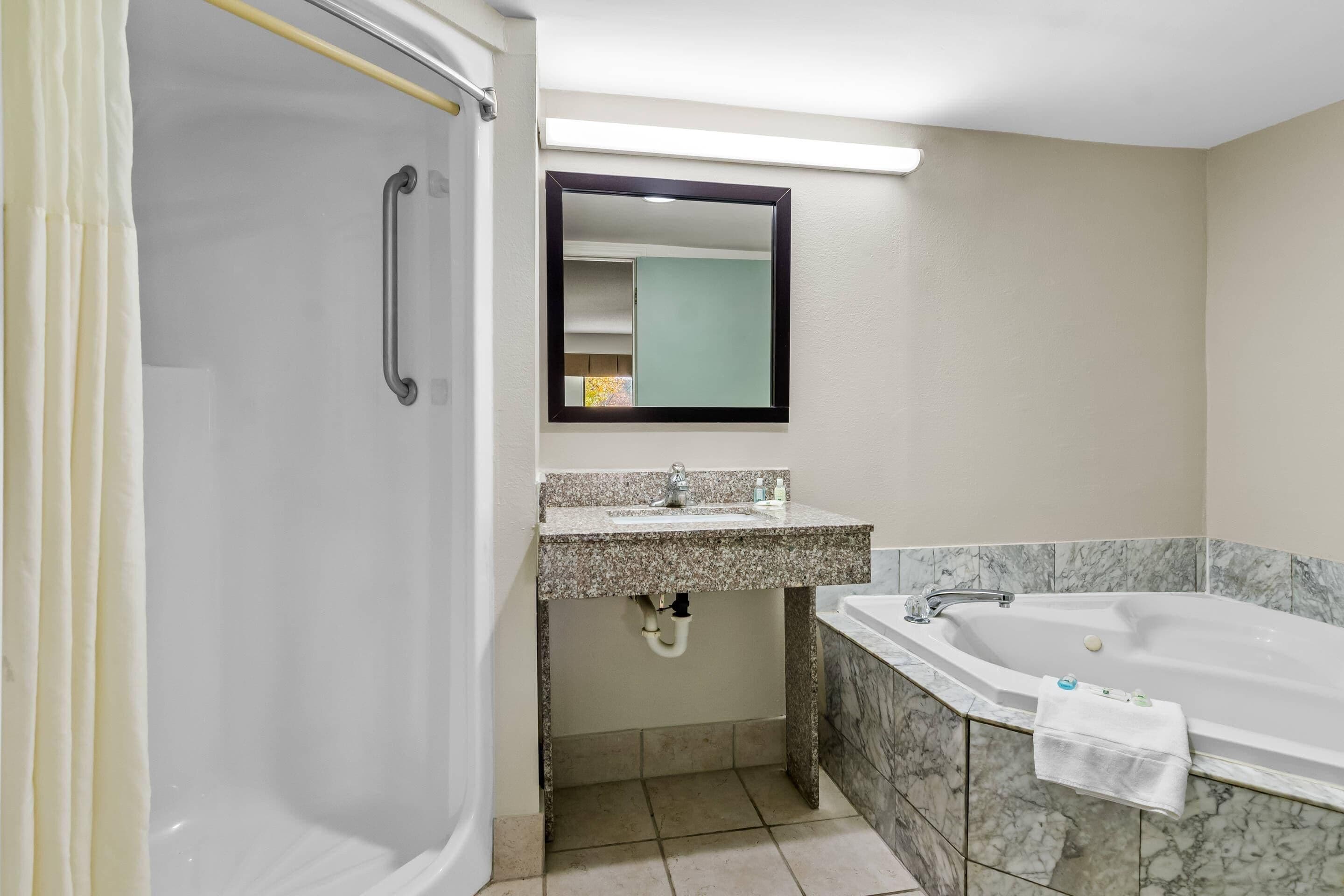 A bathroom with a shower, sink, and bathtub.