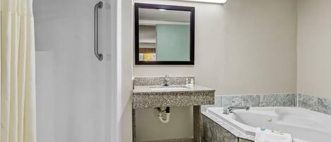 A bathroom with a shower, sink, and bathtub.