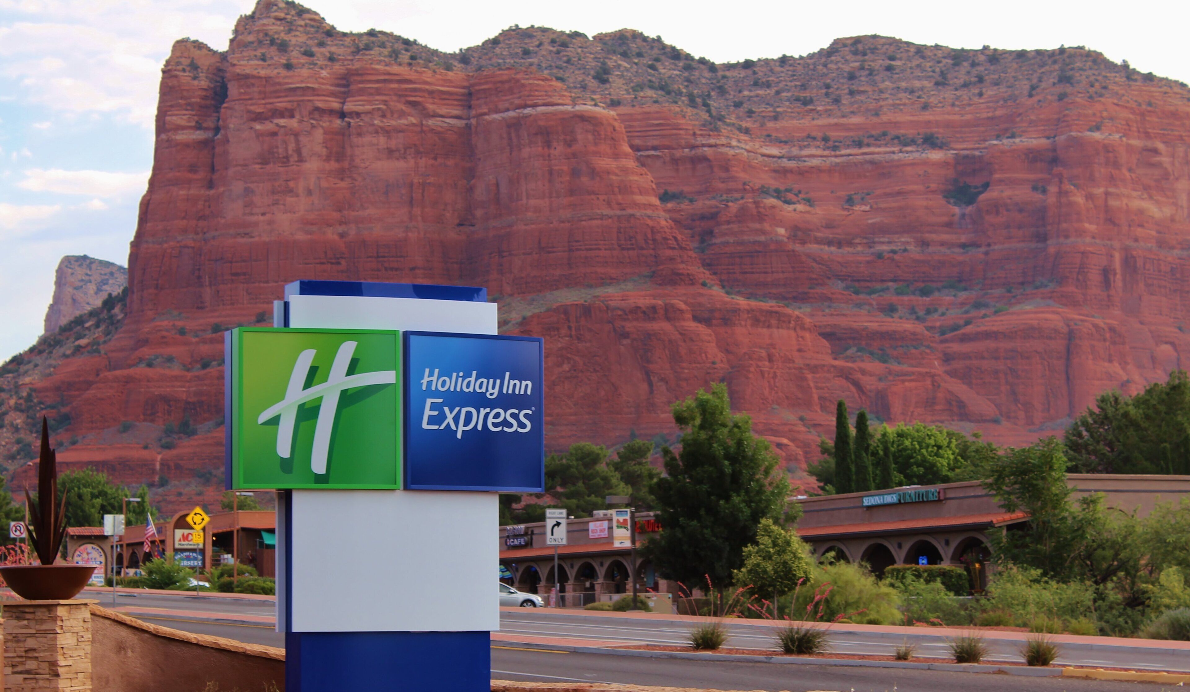 A Holiday Inn Express sign with a mountain backdrop.