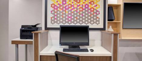 A modern office desk with a computer, keyboard, and mouse.