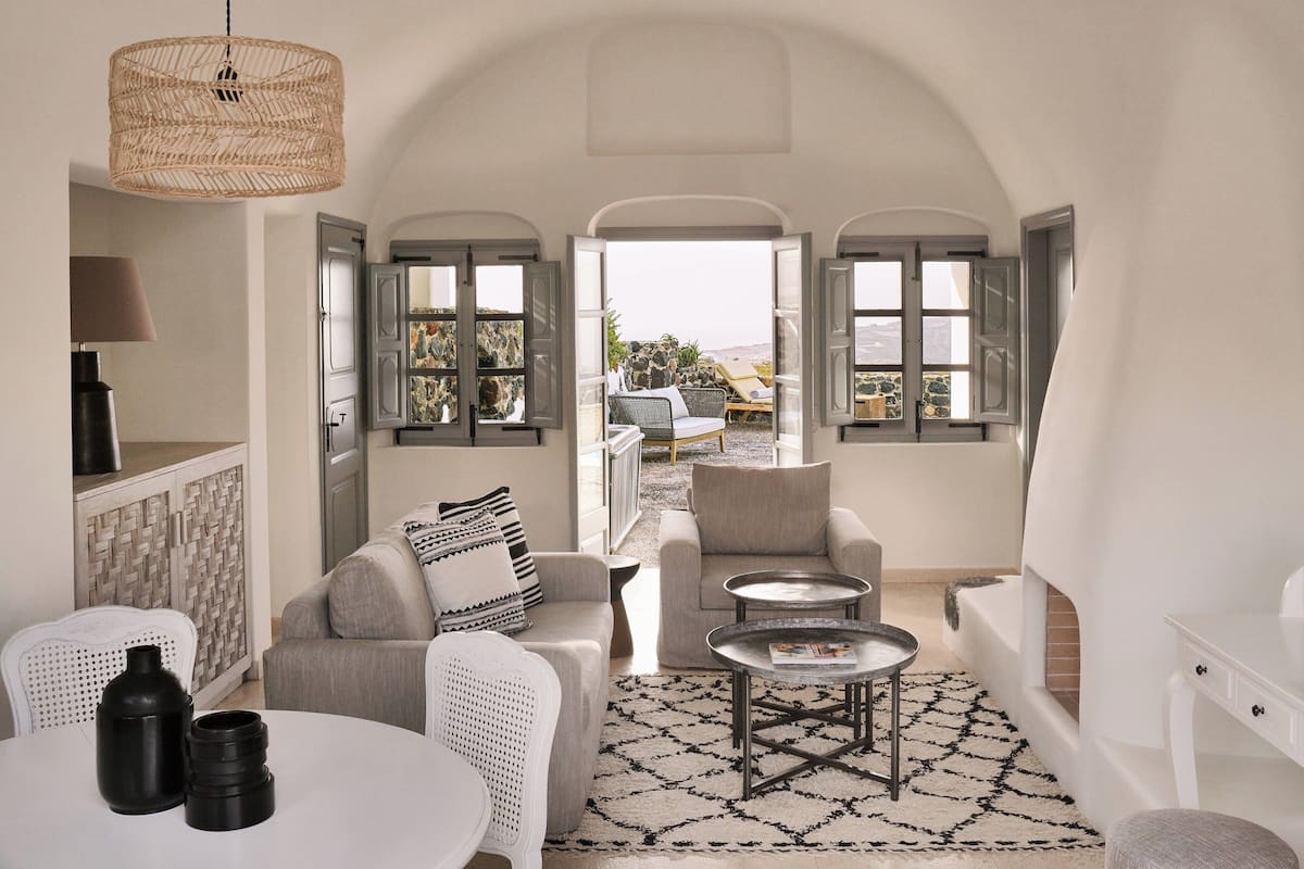 A cozy interior with a dining area, seating, and a view to the outside.