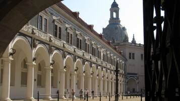 A historic building with a central dome and arched colonnades.