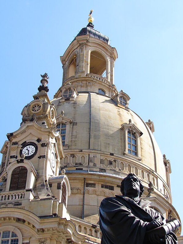 A historic building with a prominent dome, a clock tower, and a statue of a man. - Ramada by Wyndham Dresden (Dresden)