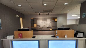 A reception desk with two computer monitors, a security camera, and a sign for 'Ustydlan Express'.