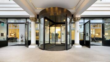 A revolving door entrance with glass panels and a central rotating mechanism.