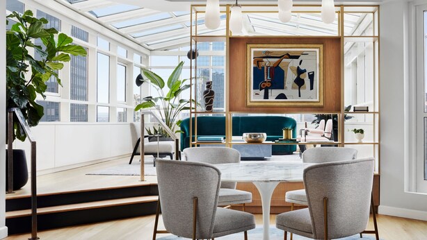 A modern dining area with a glass partition, a table, and chairs. - The London, a Luxury Collection Hotel, New York City (New York)