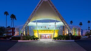 A modern building with a distinctive triangular roof and a large entrance.