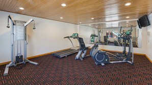 A hotel fitness center with a treadmill, elliptical, and weight machine. - Best Western Kokopelli Lodge (Clayton)