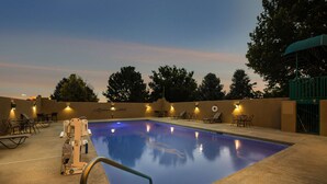 A swimming pool with a lifeguard chair, lounge chairs, and tables. - Best Western Kokopelli Lodge (Clayton)