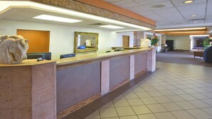 A reception area with a marble counter, a large mirror, and a statue of a horse. - Americas Best Value Inn Laredo (Laredo)